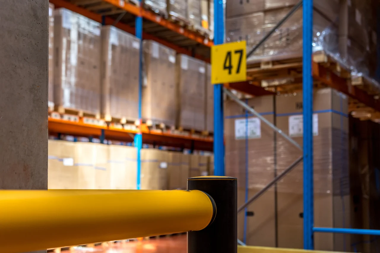 Infrastructure logistique avec racks palettes et dispositifs de sécurité en entrepôt